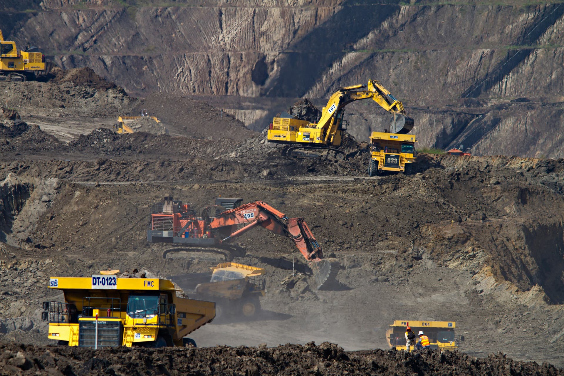 Haul trucks and excavators working an open-pit mine